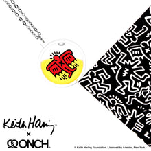 Load image into Gallery viewer, Keith Haring art with red flying devil printed on round clear acrylic pendant filled with yellow liquid