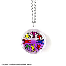 Load image into Gallery viewer, Keith Haring art with eight dancing rainbow men printed on round clear acrylic pendant filled with purple liquid 

