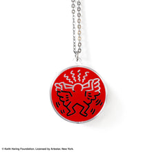 Load image into Gallery viewer, Keith Haring art with red angel printed on round clear acrylic pendant filled with black liquid 
